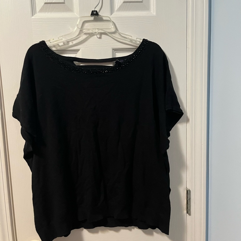 Black sweater blouse with beadwork.